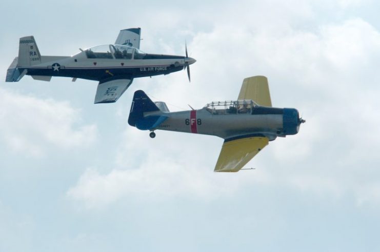 An original T-6 Texan aircraft (painted as a US Navy SNJ), right, with the new T-6 Texan II, left, at Randolph Air Force Base, Texas, in 2007