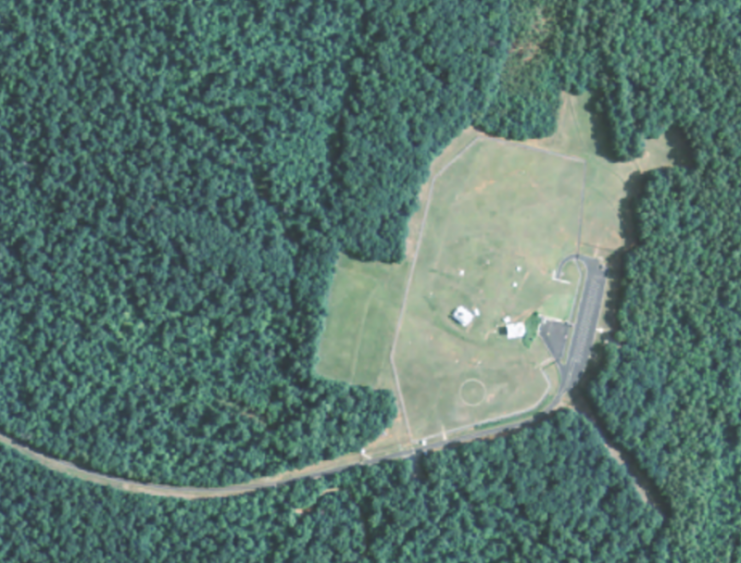 A U.S. Geological Survey satellite image shows the site of the “Big Hole” Project Office including its two above ground tropospheric scatter antennas.