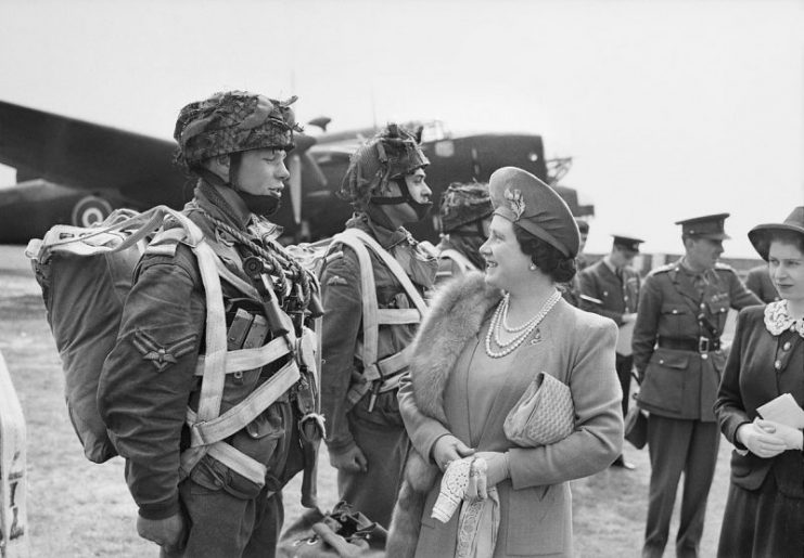 The Queen and Princess Elizabeth talk to paratroopers in front of a Halifax aircraft during a tour of airborne forces preparing for D-Day, 19 May 1944.