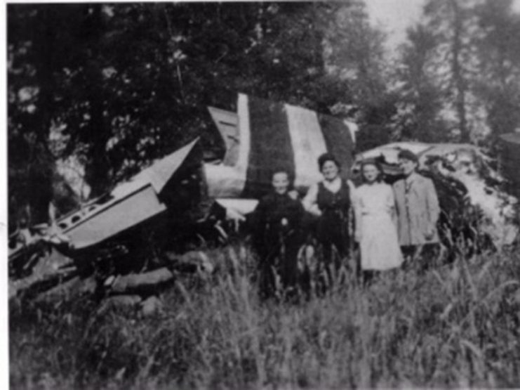 Residents of the hamlet of Founecrop pictured standing in front of the 77th Troop Carrier Squadron aircraft lost at that location on D-Day. (Picture taken in 1946)
