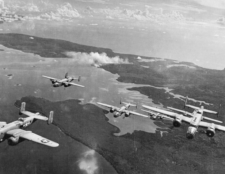 B-25 Mitchells from the 42d Bombardment fly over Bougainville from their base at Stirling Airfield, Stirling Island, Solomon Islands, 1944