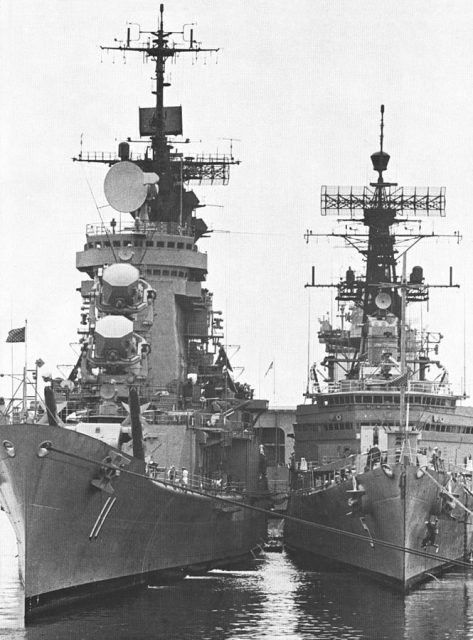 The U.S. Navy guided missile cruisers USS Chicago (CG-11) and USS Oklahoma City (CLG-5) are moored together at Naval Air Station North Island, California (USA), as Oklahoma City took over flagship duties for the U.S. First Fleet, circa 1967.