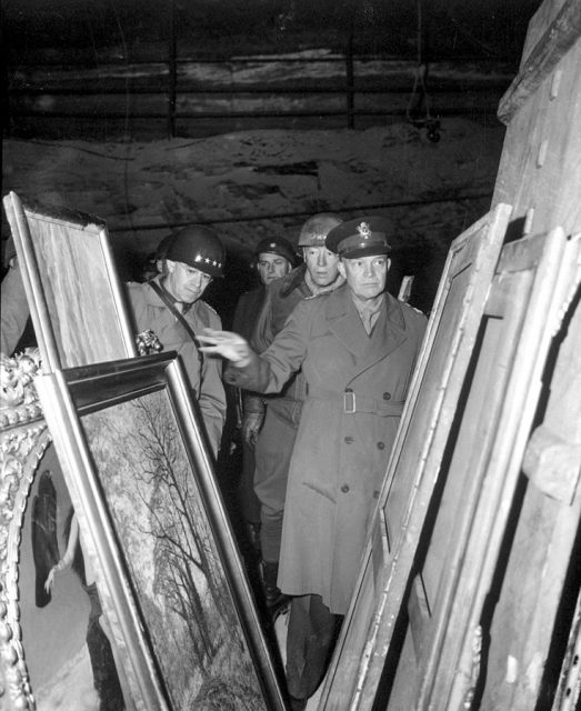 Dwight D. Eisenhower (right) inspects stolen artwork in a salt mine in Merkers, accompanied by Omar Bradley (left) and George S. Patton (center).