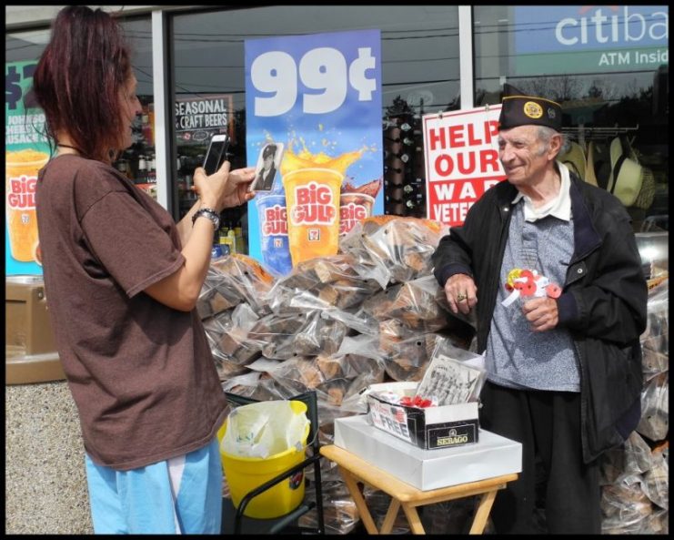 After making a donation, a customer at 7-Eleven takes a photo of Stanley’s portrait. Photo credits: David Paone