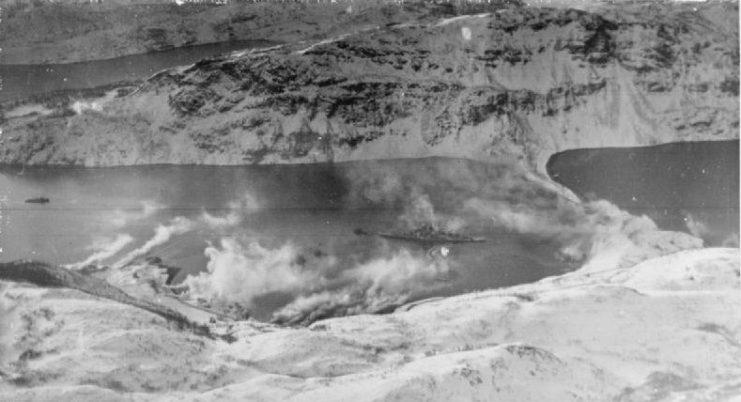 Smoke screens put up to hide the Tirpitz drifting across the waters of the fjord though the ship has not yet been hidden from view.