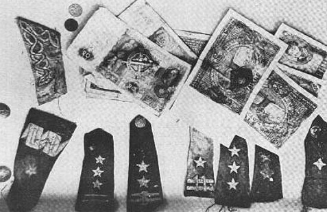 Polish banknotes and epaulets recovered from mass graves