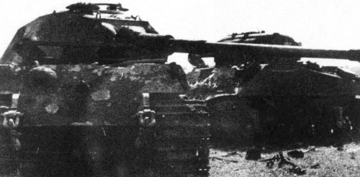 A King Tiger of the 503rd heavy tank battalion, after it has been rammed by a British Sherman commanded by Lieutenant John Gorman of the 2nd Armoured Irish Guards, Guards Armoured Division during Operation Goodwood.