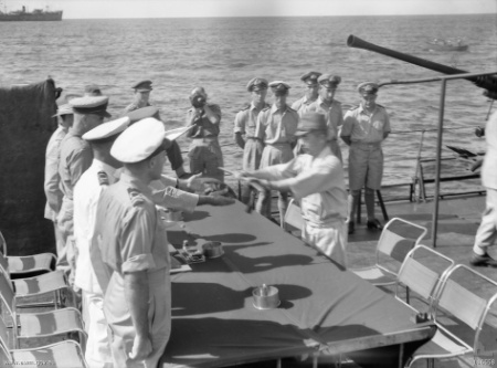 Surrender aboard HMAS Diamantina. Japanese commander Hisayuki Soeda hands his sword to J. R. Stevenson, the Australian commander