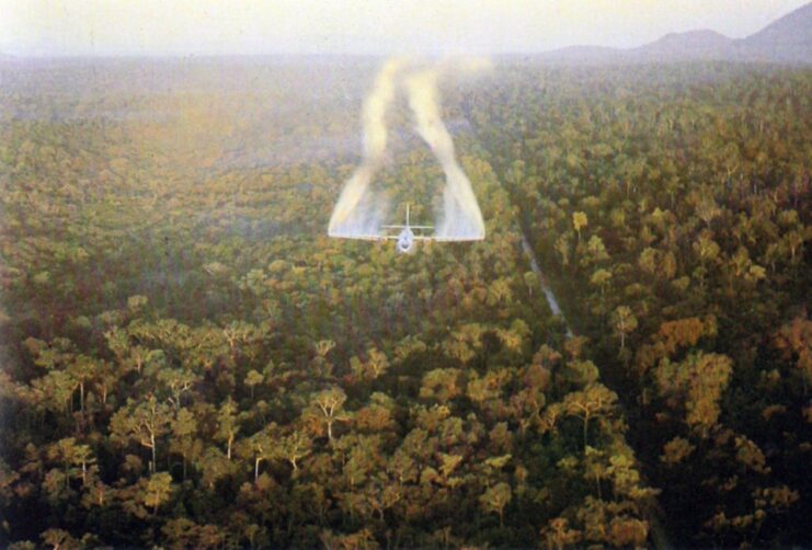 Fairchild UC-123B Provider spraying herbicide over a forest