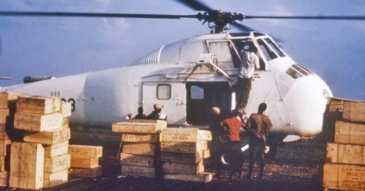 A helicopter at a makeshift airport in Calabar, Nigeria, is loaded with crates of dried fish, a staple food in that area, to be shipped to refugee camps during the Nigerian-Biafran war.