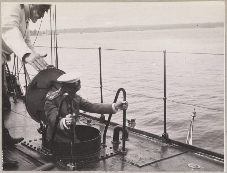 Nicholas descending into a manhole on the deck. Photo: Beinecke / Beinecke Rare Book and Manuscript Library, Yale University