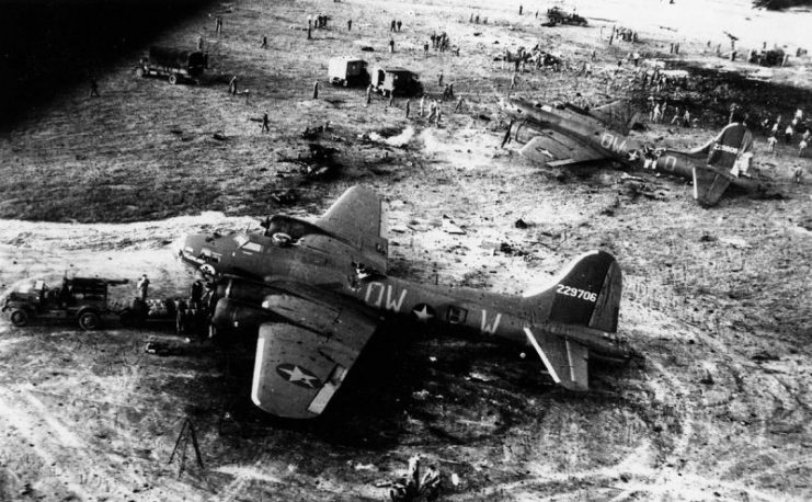 Ground crew of the 95th Bomb Group attend to an explosion caused whilst loading bombs into a B-17 Flying Fortress at Alconbury. Aircraft pictured are: B-17F (serial number 42-29808) and B-17F (serial number 42-29706), nicknamed “Passion Flower” (after the Disney character from ‘Bambi’) – both were written off as a result of the explosion.