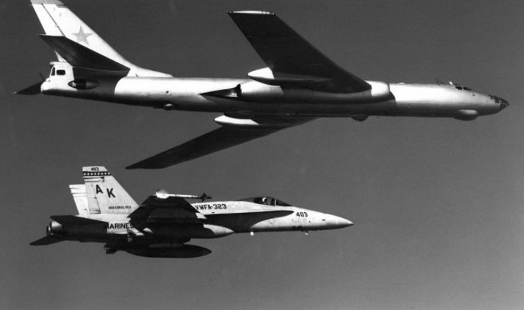 A Soviet Tupolev Tu-16 Badger aircraft being escorted by a U.S. Marine Corps McDonnell Douglas F/A-18A Hornet aircraft from Marine fighter-bomber squadron VFMA-323 Death Rattlers in 1985.
