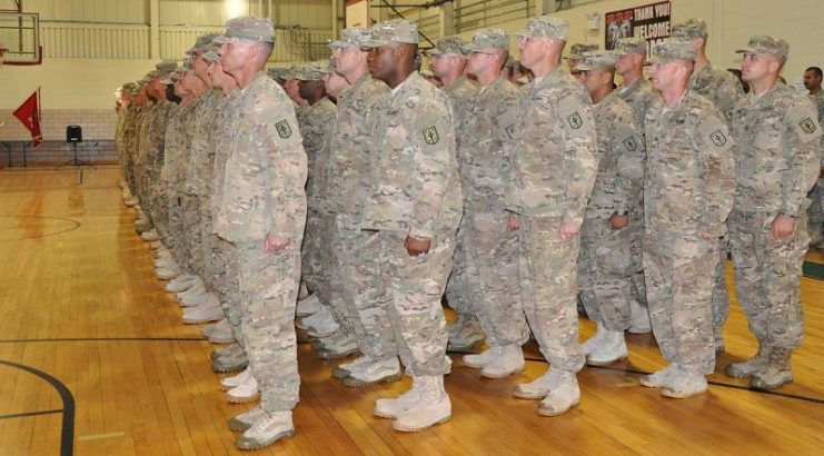More than 120 soldiers with the 232nd Eng. Co., 94th Eng. Bn., 4th MEB, 1st Inf. Div., stand in formation at a redeployment ceremony held in their honor at Swift Fitness Center here, Oct. 8. The unit returned from a nine-month deployment where they supported missions in both Kuwait and Afghanistan.