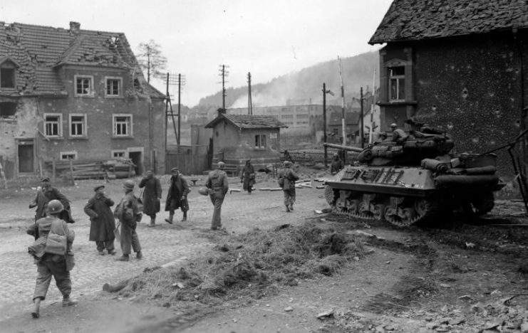 Troops from 45th ID with group of liberated Russian slave laborers in Niederwurzbach, 23 March 1945