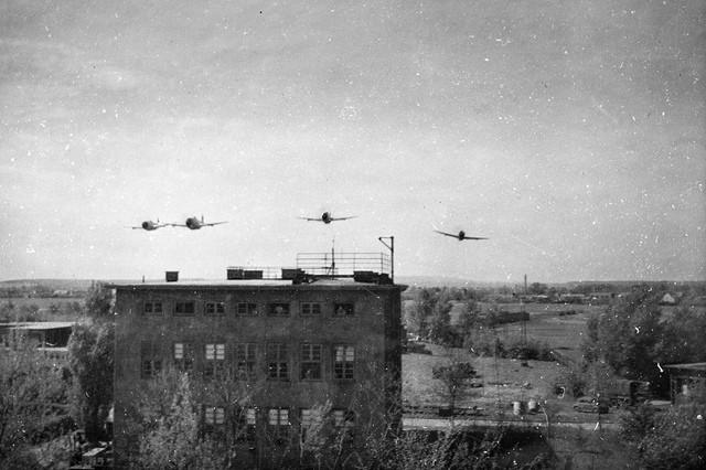 1945 World War II photo of American Republic P-47 Thunderbolts buzzing American troops in Brunswick, Germany