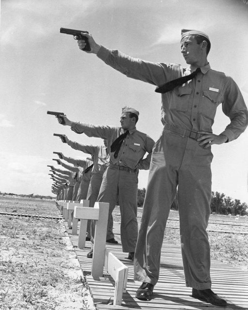 Naval Aviation Cadets from the Naval Air Station at the pistol range with Colt M1911-A1 .45 pistols, Corpus Christi, Texas, United States, circa 1941.