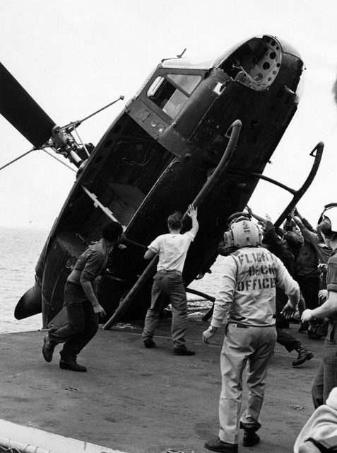 A South Vietnamese helicopter is pushed over the side of the USS Okinawa during Operation Frequent Wind, April 1975. The helicopter, which carried two Vietnamese officers, a woman, and two children, had to be disposed of to make room for the extensive Marine Corps helicopter operation helping to evacuate the city of Saigon.