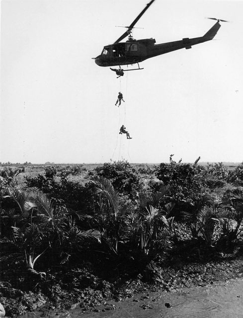 U.S. Navy SEALS rappel down ropes from a U.S. Army Bell UH-1B Iroquois helicopter to set an ambush in the jungle below during operations in South Vietnam, 1967.