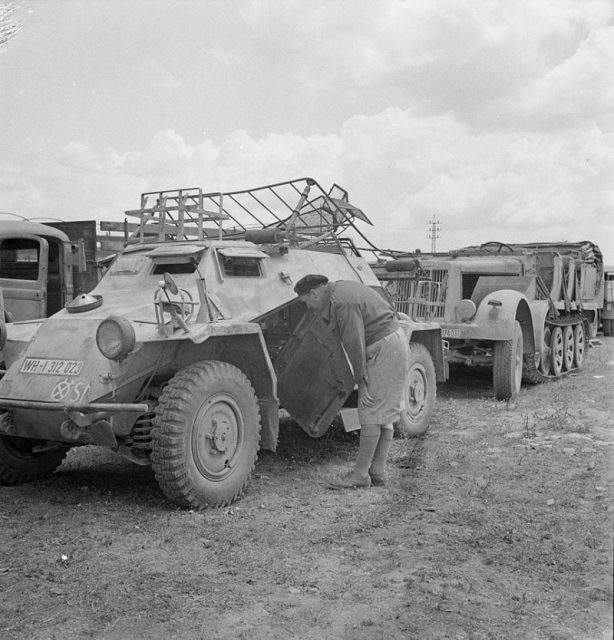 A British soldier inspecting a German SdKfz 223 “Leichter Panzerspähwagen (Fu)” armoured car after the German surrender in Tunisia in May 1943.