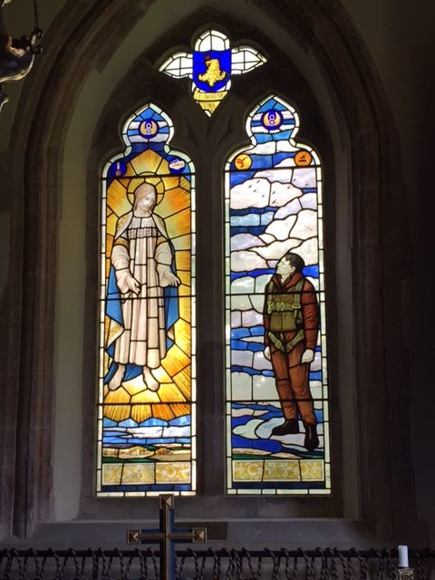 The original stained glass windows depicting Jesus welcoming an 8th Air Force crewman into heaven, at St. Andrew’s church in the village of Quidenham.