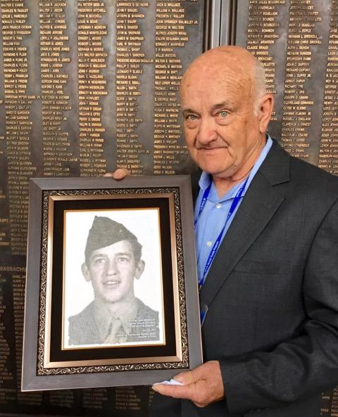 Robert “Bob” Thorn, nephew of PFC Edward Thorn, holding his uncle’s portrait at the War Memorial of Korea in Seoul, April 2018. (Photo credit: Ned Forney)