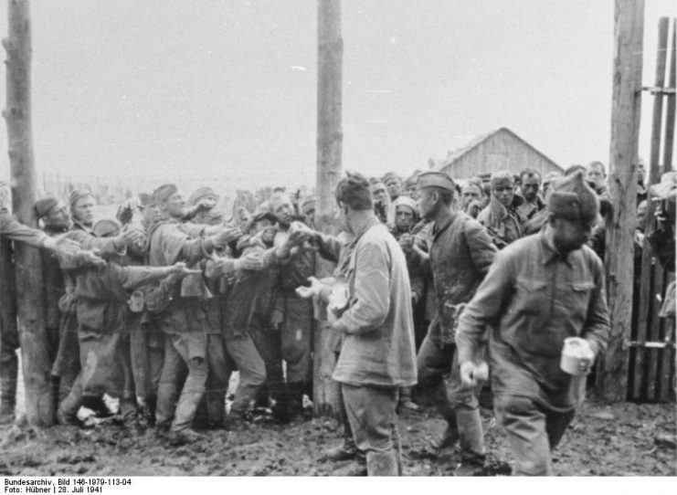 Distribution of food in a POW camp near Vinnytsia, Ukraine. July 1941. By Bundesarchiv – CC BY-SA 3.0 de