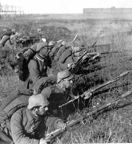 German soldiers (wearing distinctive pickelhaube helmets with cloth covers) on the front line at the First Battle of the Marne.