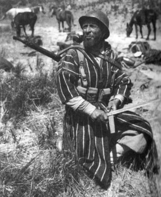 Moroccan Goumier sharpening his bayonet. Italy 1944.