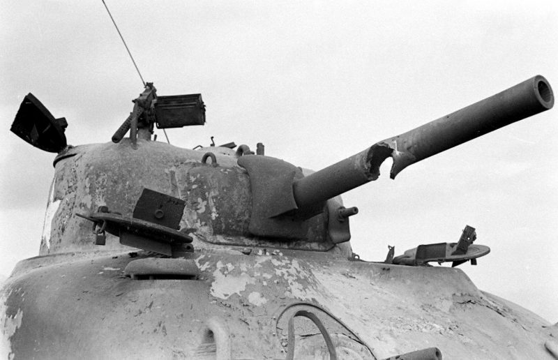 Shot through the barrel of a M4A1 Sherman tank burnt out in a field in Italy 