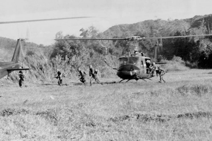 Soldiers of the U.S. Amry 1/7th Cavalry disembark from a Bell UH-1D Huey at LZ X-Ray during the Battle of Ia Drang.