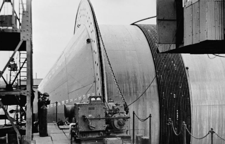 Petrol pipe for Operation PLUTO being wound onto a ‘ConunDrum’ pipe-laying device, June 1944.