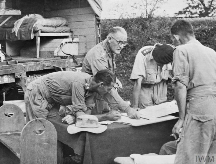 British Personalities: Major General D T Cowan (centre, wearing spectacles), GOC (General Officer Commanding) 17th Indian Division, at a staff conference.