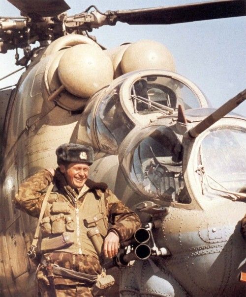 Soviet Soldier next to Mi-24P in Afghanistan