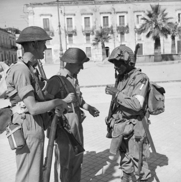 British troops of the 6th Battalion, Durham Light Infantry, part of the British 50th Division, with an American paratrooper of the 505th Parachute Infantry Regiment, part of the U.S. 82nd Airborne Division, in Avola, 11 July 1943.