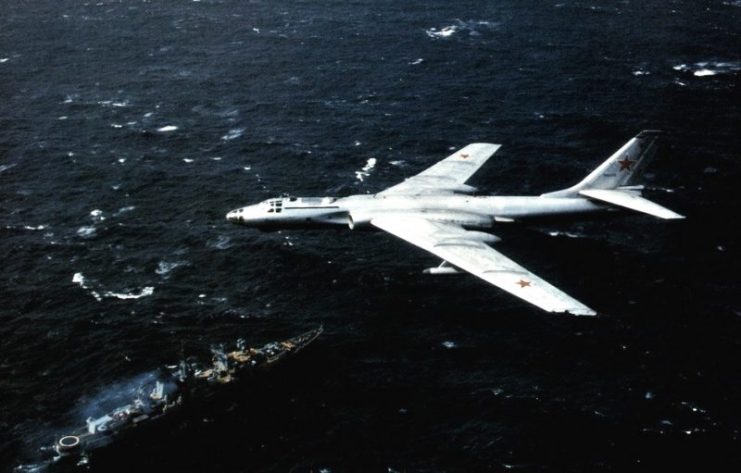 A Soviet Tupolev Tu-16 (NATO reporting code “Badger”) in flight in 1984 above a Nikolaev class cruiser (NATO reporting code “Kara”).