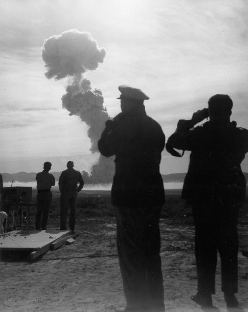 Secretary of Defense Charles E. Wilson and designated Chairman of the Joint Chiefs of Staff Admiral Arthur W. Radford observing history’s first atomic artillery shell explosion.