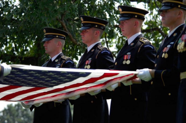Army Color Guard members fold a flag from the casket of 2nd Lt. Harold Elton Hoskin during a burial ceremony Sept. 7 at Arlington National Cemetery in Virginia. Lieutenant Hoskin was one of five men who were flying in a B-24 Liberator that crashed while on a test flight Dec. 21, 1943, out of Ladd Field in Fairbanks, Alaska. Lieutenant Hoskin’s remains were discovered in August 2006 and identified in April 2007. (U.S. Air Force photo/Tech. Sgt. Cohen A. Young)