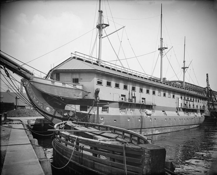 USS Constitution as a barracks ship ca. 1905 with the caisson gate for Dry Dock No. 1 at the Charlestown Navy yard floating in the foreground