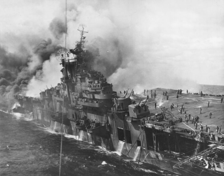 The U.S. Navy aircraft carrier USS Franklin (CV-13) afire and listing after a Japanese air attack, off the coast of Japan, 19 March 1945.