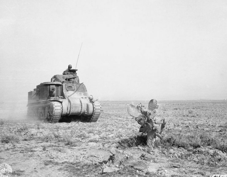 Grant tank advancing to support American forces in Tunisia , 1943.