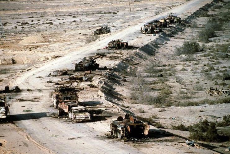 Aerial view of destroyed Iraqi T-72 tank, BMP-1 and Type 63 armored personnel carriers and trucks on Highway 8 in March 1991