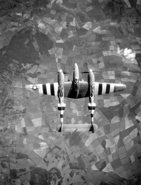 Reconnaissance P-38 with bold black and white invasion stripes participating in the Normandy Campaign