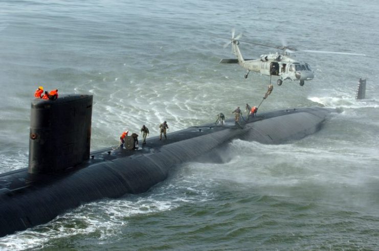 Navy SEALs from SEAL Delivery Vehicle Team 2 (SVD-2) perform a fast-rope exercise moving from a helicopter to the topside of Los Angeles Class submarine USS Toledo (SSN 769).Photo: Marion Doss CC BY-SA 2.0