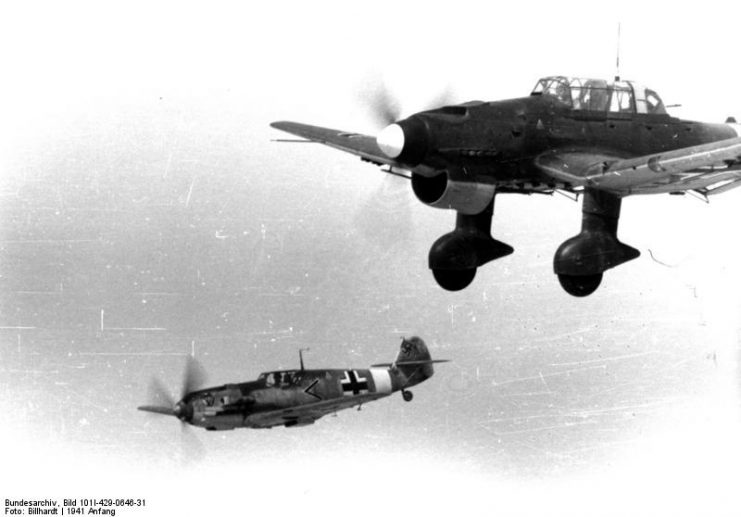 German Bf 109E fighter of I./JG 27 and Ju 87B Stuka aircraft of II./St G 2 in flight, early 1941. Photo: Bundesarchiv, Bild 101I-429-0646-31 / Billhardt / CC-BY-SA 3.0