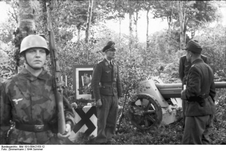 Lieutenant of the Luftwaffe, paratroopers, table with candles and picture of Hermann Göring, Normandy 1944. By Bundesarchiv – CC BY-SA 3.0 de