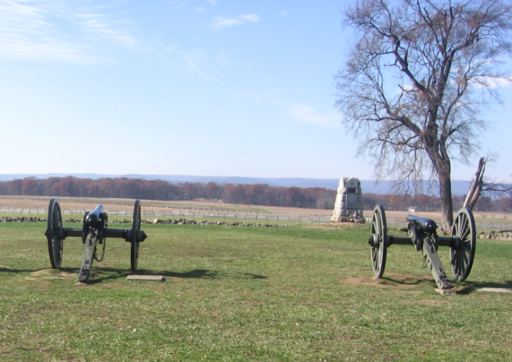 Cannons at Gettysburg battlefield representing Hancock’s defenses, stormed by Pickett’s Charge. 71st Pennsylvania Infantry Monument in middle ground. Photo by Joshua Sherurcij