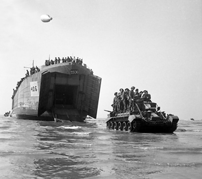 Cromwell pursuit tank with men aboard, D-Day.