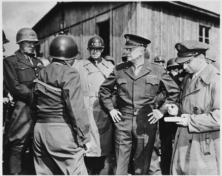 High-ranking U.S. Army officers inspect the newly liberated Ohrdruf concentration camp. Among those pictured are: Generals Dwight D. Eisenhower, George Patton and Omar Bradley. Also pictured is Jules Grad, correspondent for the U.S. Army newspaper, “Stars and Stripes” (at the far right).
