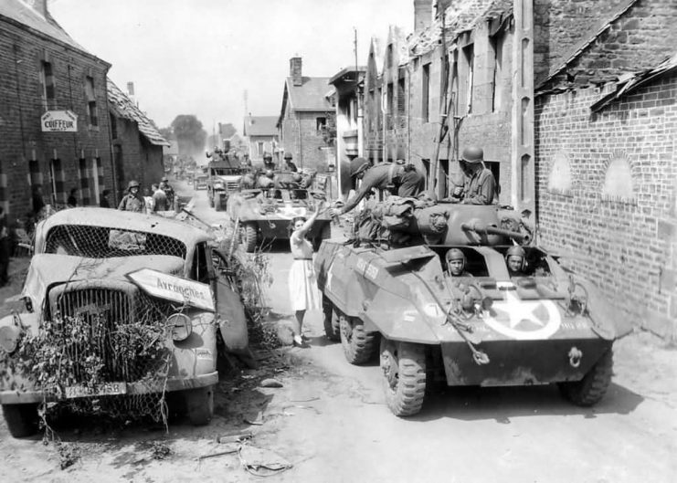 M8 Greyhound Armored Cars of the 2nd Cav Group Enter Brehal Normandy August 2 1944.